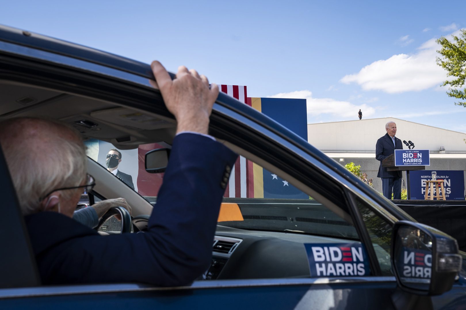 Supporters listen in their cars as Democratic presidential nominee Joe Biden speaks during a drive-in campaign rally at Riverside High School on Sunday, Oct. 18, 2020 in Durham, North Carolina.