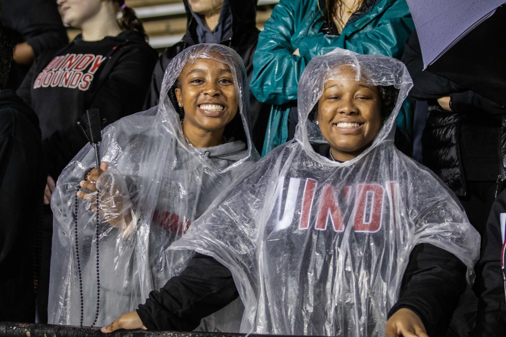 Fans at football game in the rain