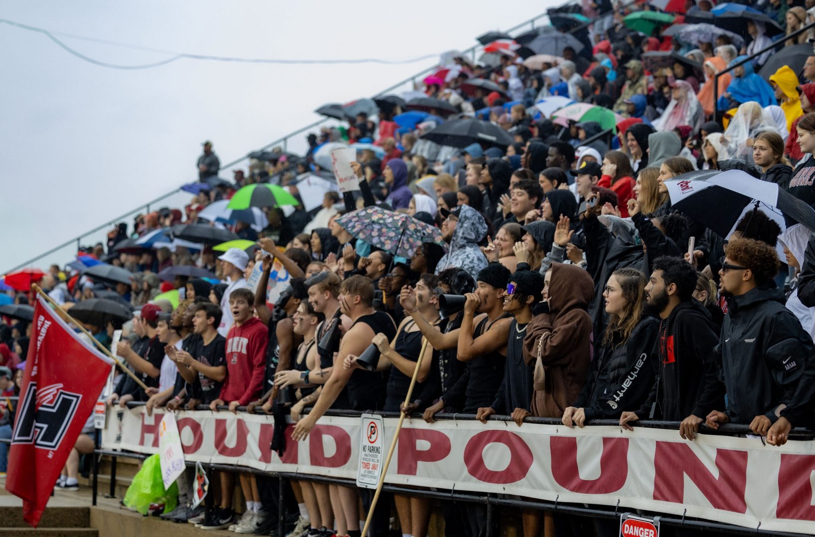 Fans at football game in the rain