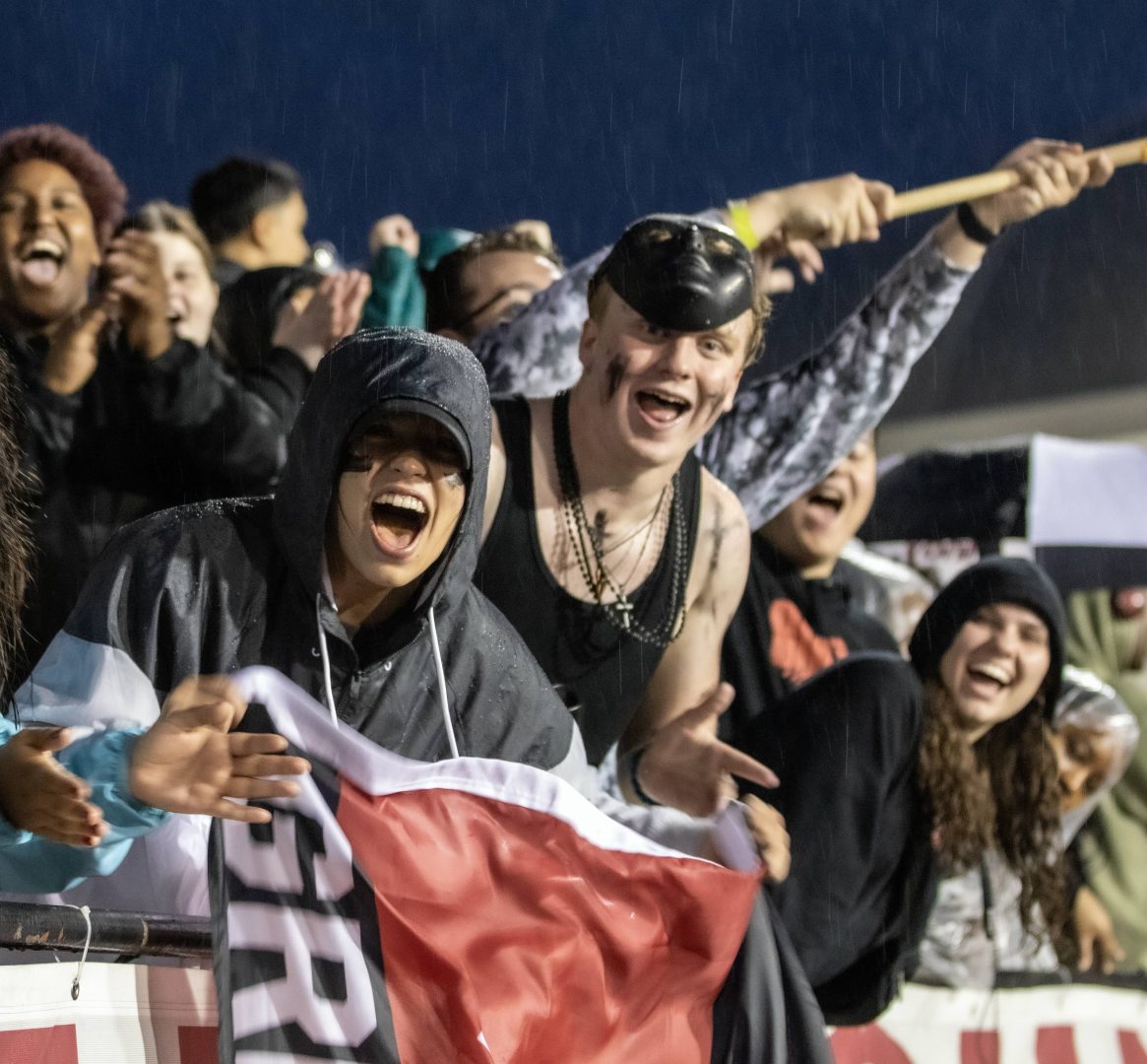 fans in the rain at homecoming game