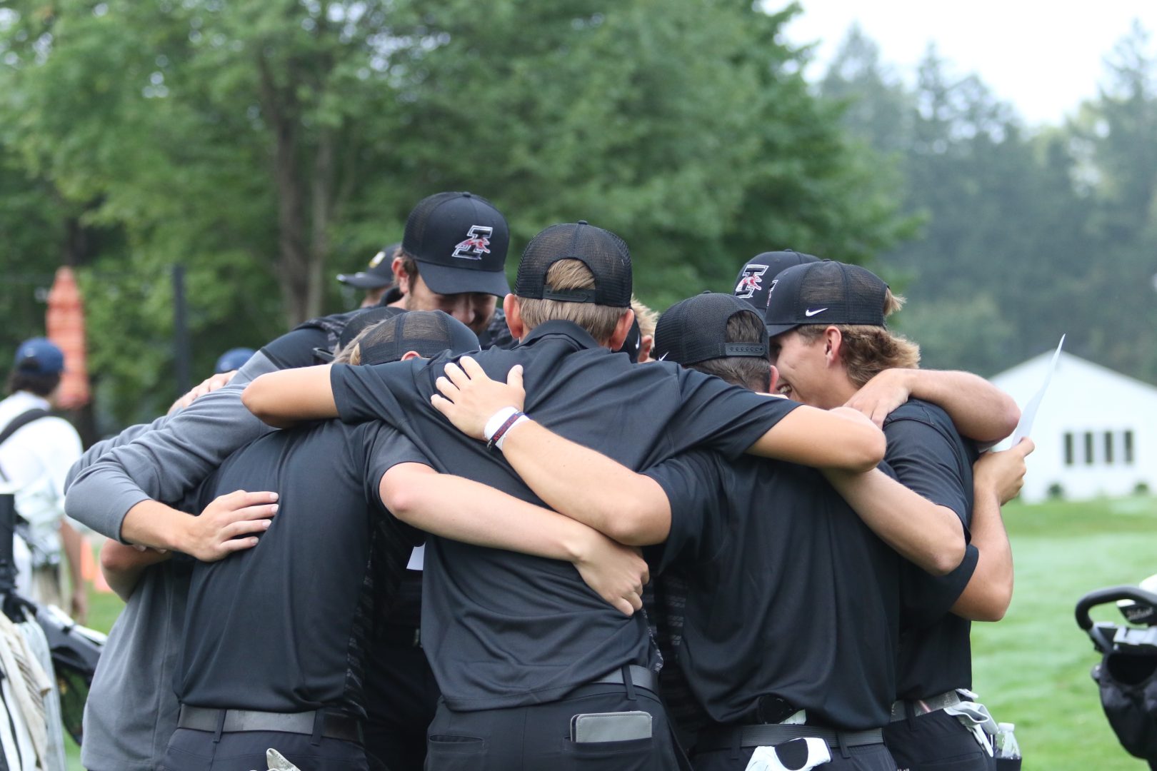 Golf team in huddle