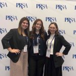 Three girls stand together at the PRSA conference.