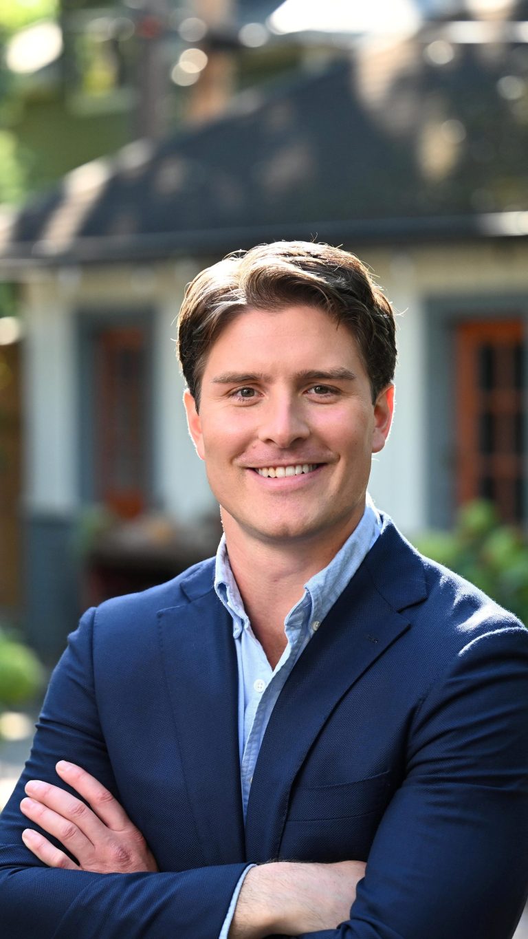 Beau Bayh smiling near a house