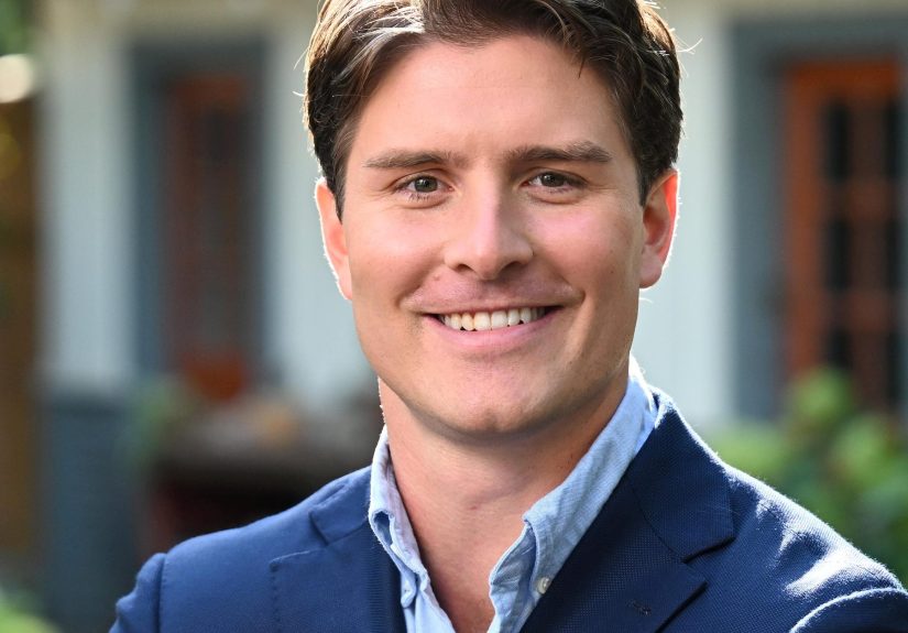 Beau Bayh smiling near a house