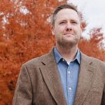 Mitch Gore standing in front of a tree in the fall