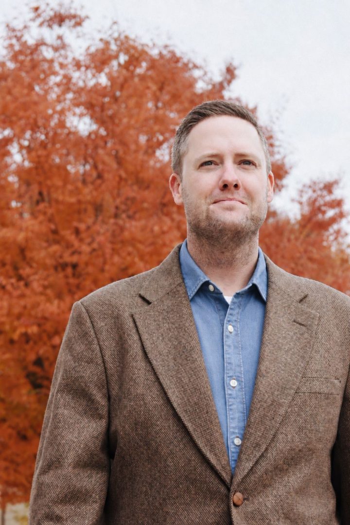 Mitch Gore standing in front of a tree in the fall.