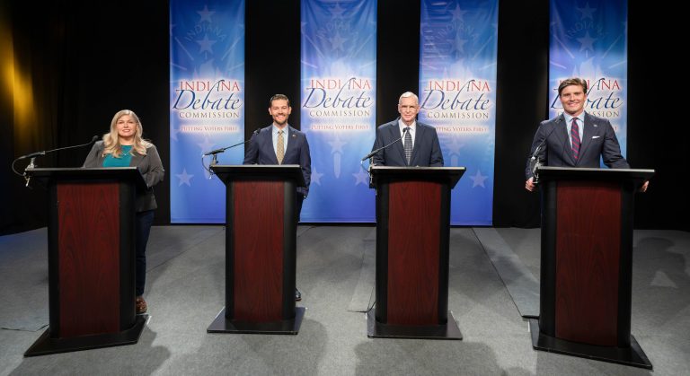 Lauri Shillings, Max Engling, Greg Ballard, and Beau Bayh standing behind podiums at the Indiana Secretary of State debate.