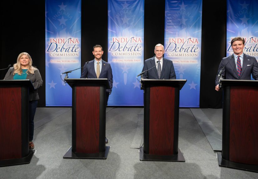 Lauri Shillings, Max Engling, Greg Ballard, and Beau Bayh standing behind podiums at the Indiana Secretary of State debate.
